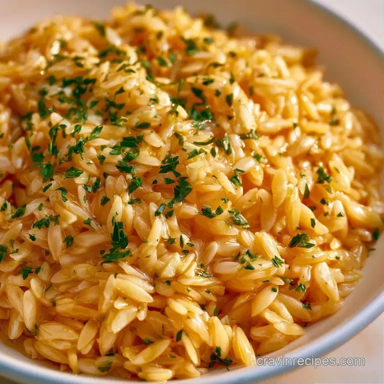 Elegant white bowl of creamy, golden pasta topped with a dollop of butter and finely chopped parsley on a linen cloth.